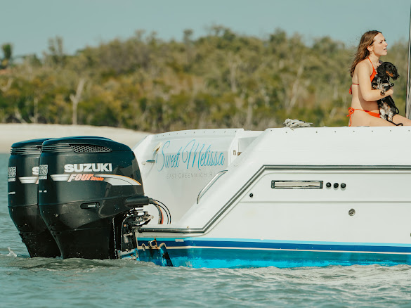 Guest with dog on the stern of the Sweet Melissa